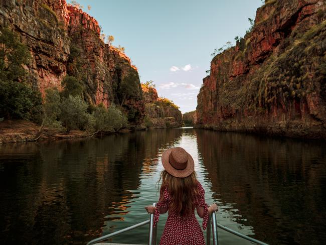 ESCAPE: A visitor stands at the front of a cruise boat as it travels along Katherine Gorge. Nitmiluk National Park covers a vast area of escarpment country, including 13 gorges along the Katherine River carved from the ancient sandstone country. Picture: Tourism NT/Emilie Ristevski