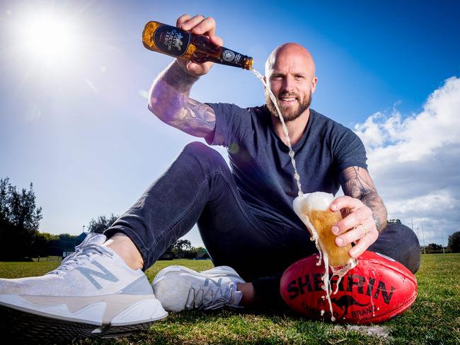 Melbourne captain Nathan Jones celebrates the Demons’ first finals appearance for more than a decade by pouring a Carlton Zero beer. Picture: Jake Nowakowski