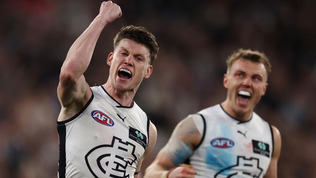 Sam Walsh with his mouthguard and Patrick Cripps in the background with a more traditional protective guard.. Photo by Michael Klein.