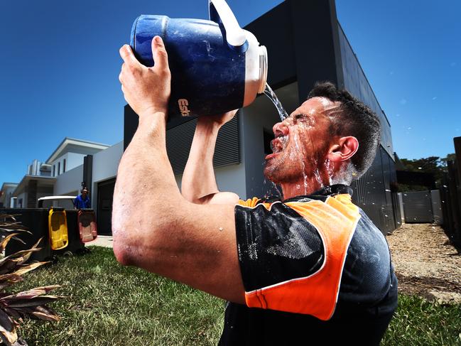 Electrician Paul Daquino of Rupertswood cools off on a construction site in Rosslea. Picture: Zak Simmonds