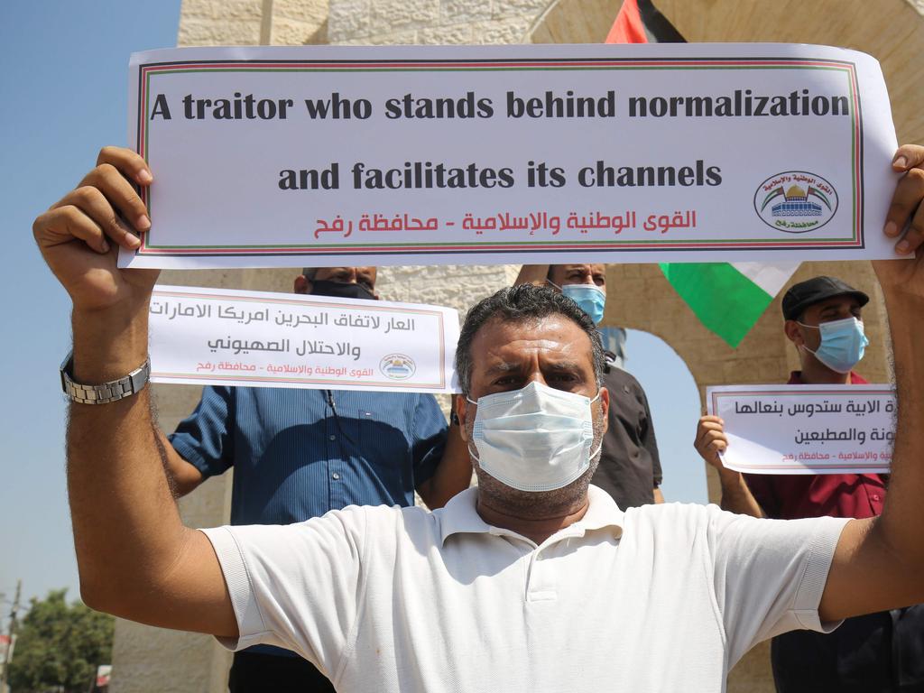 Palestinians carry placards during a protest in Rafah in the southern Gaza Strip, on September 12, 2020, to condemn the normalisation of ties between Israeli and Bahrain. - The Palestinian cause has long cemented ties between Middle East nations with divergent interests, but amid shifting regional alliances they are increasingly isolated and in need of new friends, analysts say. In the latest blow, Bahrain broke ranks and agreed on Friday to open diplomatic ties with Israel, in a deal announced in Washington by President Donald Trump. (Photo by SAID KHATIB / AFP)