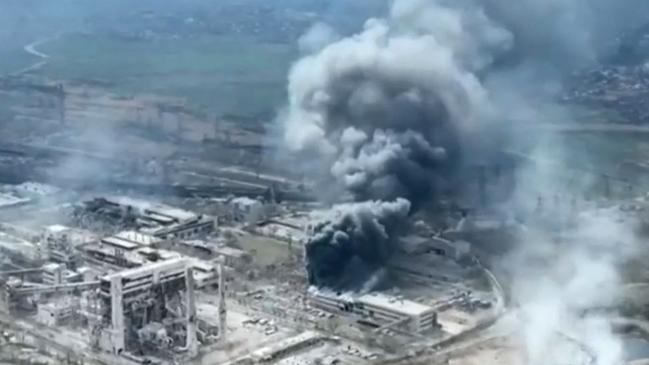 Clouds of smoke billowing above Azovstal steel plant and the destroyed gates of Azov Shipyard during the Russian assault. Picture: AFP.