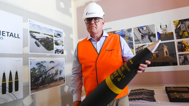 Former prime minister Scott Morrison holds a 155mm artillery shell during a 2021 visit to the NIOA/Rheinmetall factory in Maryborough, Queensland. Picture: AAP