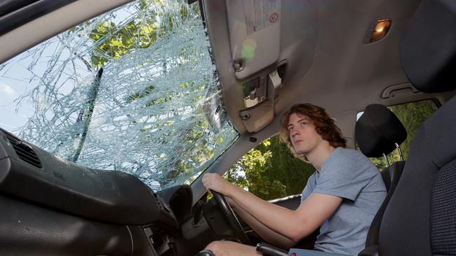 Ringwood North’s Zac Thiessen in his car, which was destroyed by a deer. Picture: Mark Dadswell