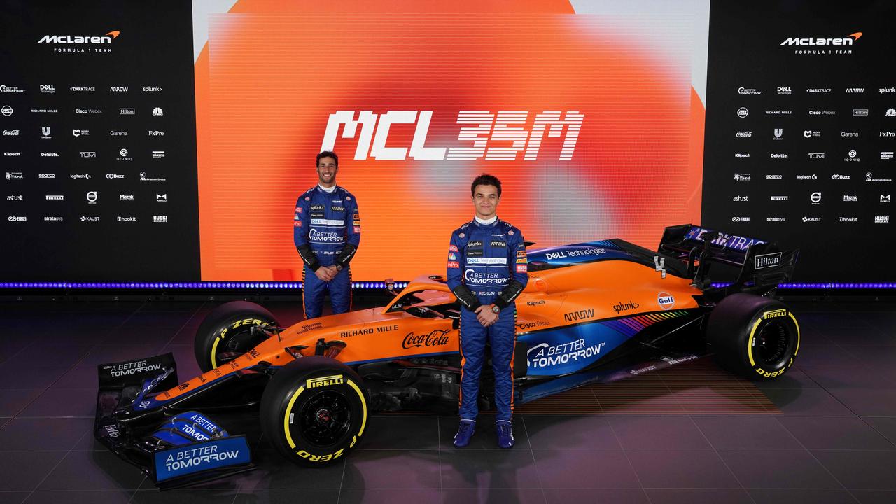 Daniel Ricciardo and Lando Norris reveal the 2021 McLaren. (Photo by Handout / McLAREN / AFP)