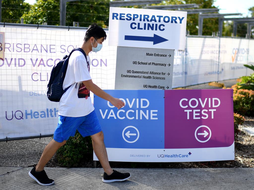 A masked man walks outside a Brisbane Covid-19 vaccine and testing clinic this week. Picture: Dan Peled/NCA NewsWire