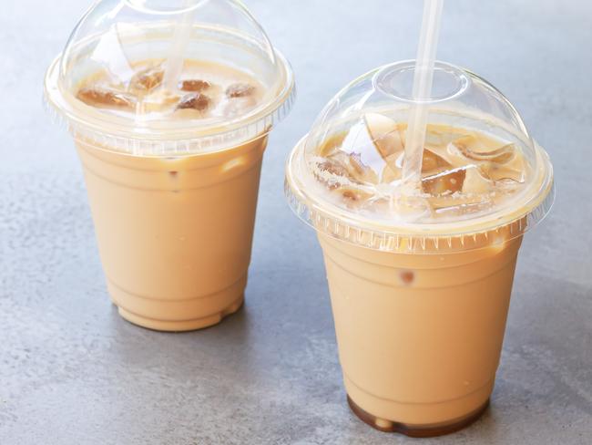 Two iced coffee or latte in take away plastic cup on street cafe stone table. Picture: iStock