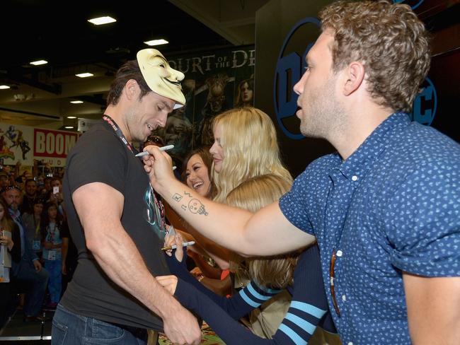 Henry Cavill gets his shirt signed by Aussie stars Margot Robbie and Jai Courtney at Comic-Con in 2016. Picture: Charley Gallay/Getty Images for DC Entertainment