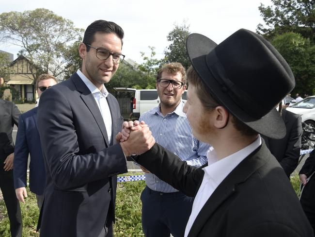 Josh Burns MP meets people gathered outside the Addass Israel synagogue at East St Kilda. Picture: Andrew Henshaw