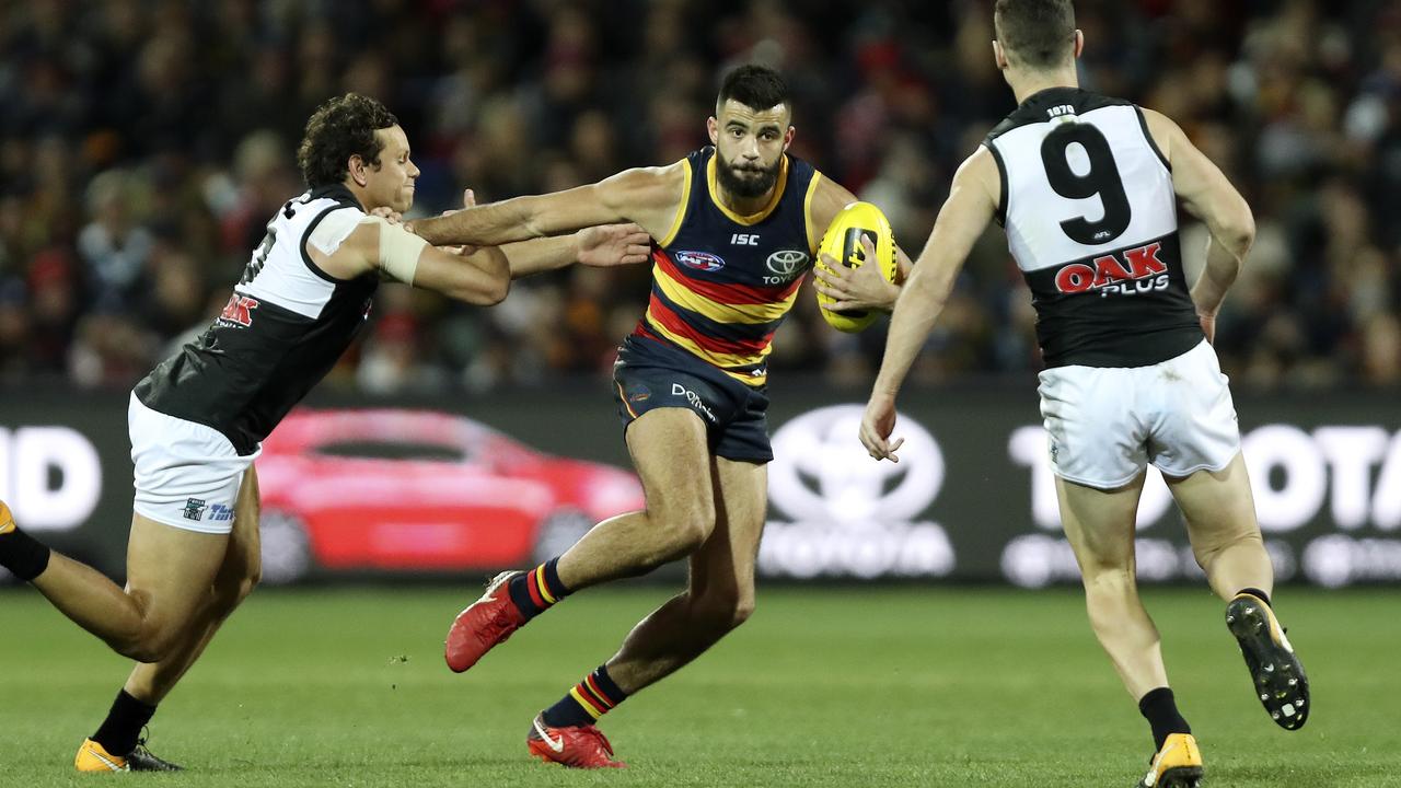 Wayne Milera breaks away from Port Adelaide’s Steven Motlop in Showdown 45. Picture SARAH REED