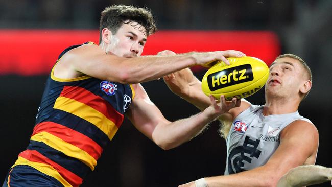 Mitch McGovern grabs the ball in front of Carlton’s Liam Jones, who could be his teammate next season. Picture: David Mariuz/AAP