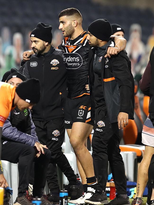 Alex Twal is assisted from the field. Picture: AAP