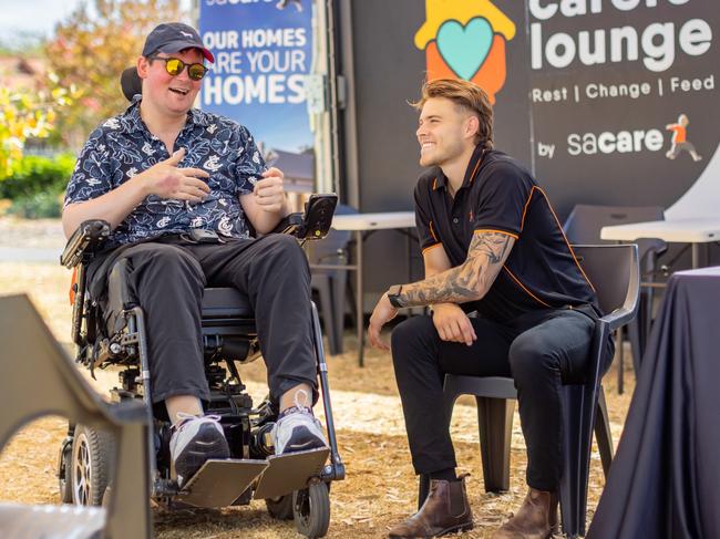 Best Community Program winner was SACARE Oncall Group, SA. Sam and his carer, Dan, sit underneath the shade sail in the outdoor area of The Carers Lounge at the 2024 Adelaide Fringe. Picture: Supplied