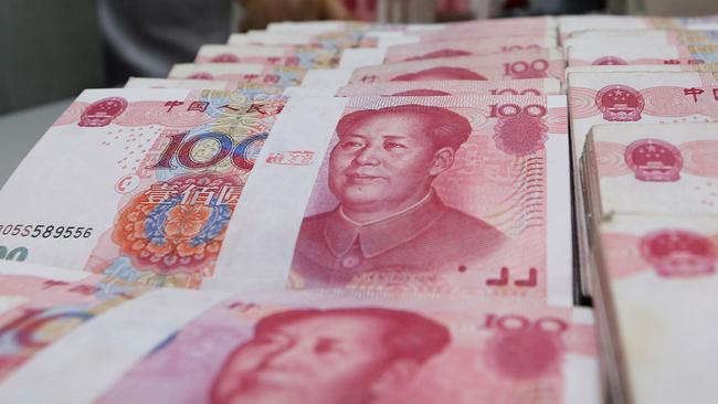 A teller counts yuan banknotes in a bank in Lianyungang, east China's Jiangsu province on August 11, 2015. China's central bank on August 11 devalued its yuan currency by nearly two percent against the US dollar, as authorities seek to push market reforms and bolster the world's second-largest economy. CHINA OUT AFP PHOTO