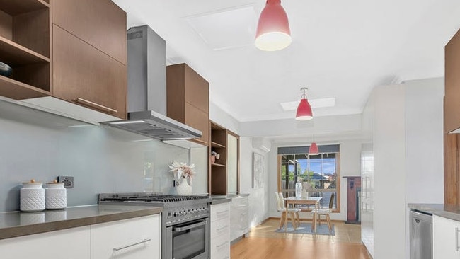 The kitchen has stainless-steel 900m appliances, a dual freestanding oven and stone benchtops.