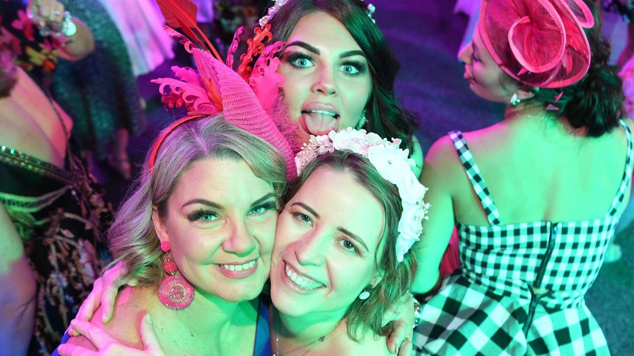 Melissa Dent and Lisa Moriarty with photobomb on the dance floor at Darwin Ladies Day. Picture: (A)manda Parkinson