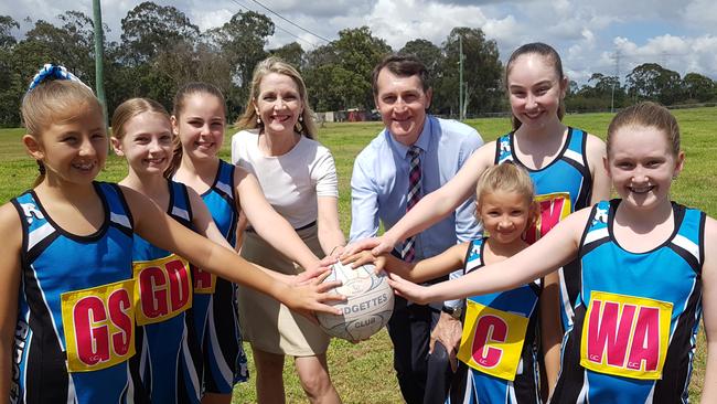 Cr Amanda Cooper (Bracken Ridge) and Lord Mayor Graham Quirk, both centre, with players from the Ridgettes Netball Club. Picture: Ellen-Maree Elliot