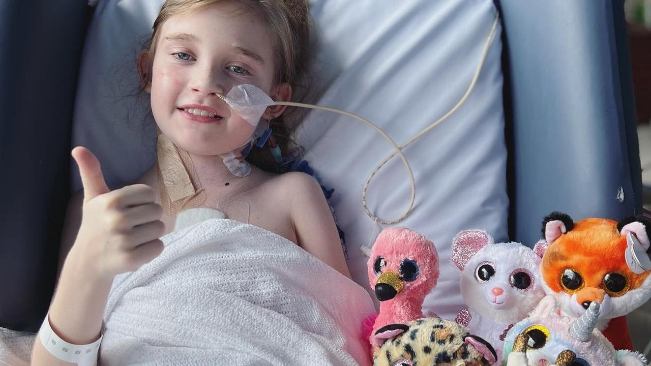 Lilli poses with her stuffed animals in the hospital.