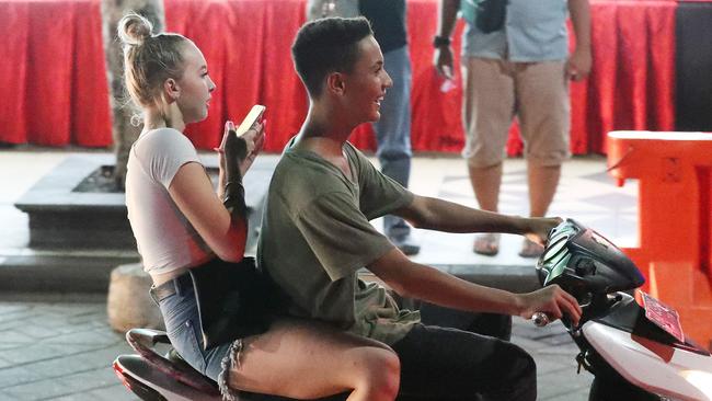 Young Australian without a helmet riding on scooter in the night club district during schoolies, Kuta, Bali. Picture: Liam Kidston