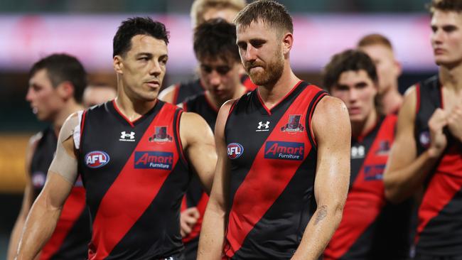 Heppell and Shiel leave the field after the Bombers went down by 58 points in a listless display. Picture: Matt King/AFL Photos/via Getty Images