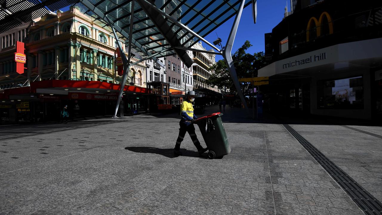 A council worker walks across an empty square in Queens Street Mall in central Brisbane. Picture: NCA NewsWire / Dan Peled