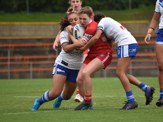 Darcy Eade is hit hard by Tarli Dennis (right). Picture: Sean Teuma/NewsLocal