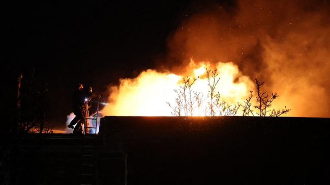 Ukrainian firefighters work on a spot following an air-attack in Dnipro on November 21, amid the Russian invasion of Ukraine. Picture: Handout/State Emergency Service of Ukraine/AFP