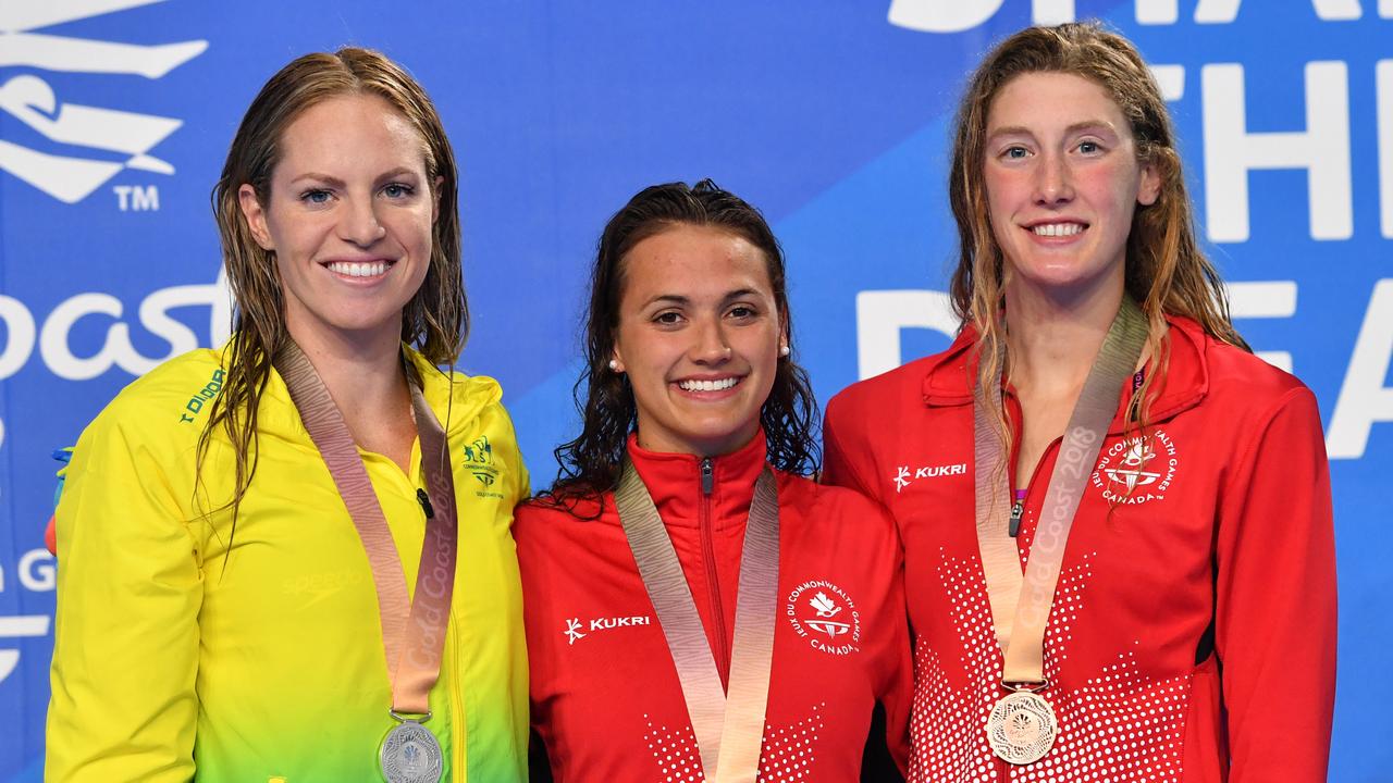 Silver medalist Emily Seebohm (from left) with gold medalist Kylie Masse and bronze medalist Taylor Ruck, both of Canada, after the 100m backstroke final.