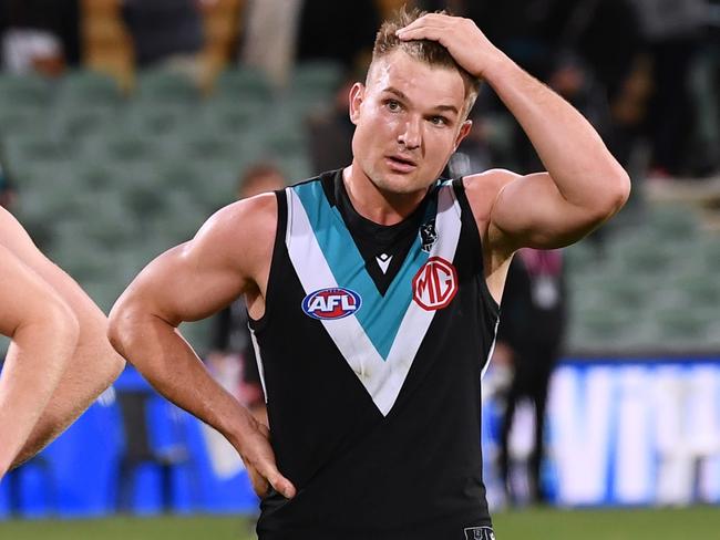 ADELAIDE, AUSTRALIA - JULY 08: Miles Bergman ,Ollie Wines and Darcy Byrne-Jones of Port Adelaide dejected after losing the round 17 AFL match between Port Adelaide Power and Melbourne Demons at Adelaide Oval on July 08, 2021 in Adelaide, Australia. (Photo by Mark Brake/Getty Images)