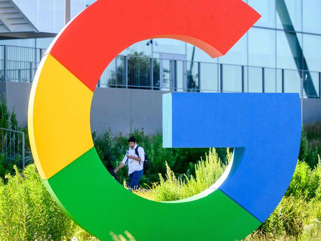 (FILES) In this file photo taken on June 28, 2022 a worker walks along a path at Googleâs Bay View campus in Mountain View, California. - The association defending the privacy of Internet users Noyb has filed a complaint with the CNIL against advertising emails distributed by Google to users of its email service Gmail, it announced on August 24, 2022. (Photo by NOAH BERGER / AFP)