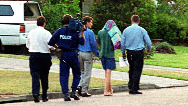 SLD (under a towel) with police after the murder of Courtney Morley-Clarke in 2001.