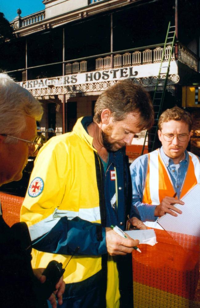 Gary Cotterill, Officer in charge of Childers ambulance out the front of the Palace Backpackers hostel in June 2000. Supplied pic: Paul/Burtell