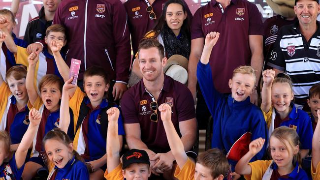 Michael Morgan with kids from the Mitchell State School. Image: Adam Head