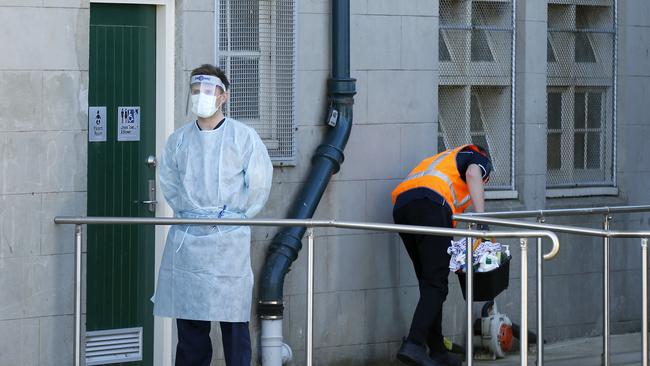 A medical professional invites the first person in for COVID testing at AG Gillen Oval in Brunswick West, one of the 12 new COVID-19 testing sites set up in Melbourne, on Wednesday morning. Picture: Darrian Traynor/Getty