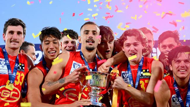 MELBOURNE, AUSTRALIA – SEPTEMBER 24: Suns players celebrate with the trophy following the 2023 VFL Grand Final match between the Gold Coast SUNS and the Werribee Tigers at IKON Park on September 24, 2023 in Melbourne, Australia. (Photo by Morgan Hancock/AFL Photos via Getty Images)