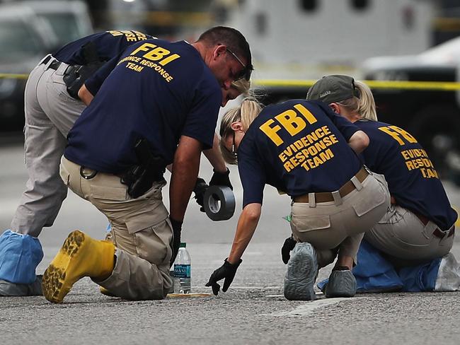 Members of an FBI evidence response team search an area that is still an active crime scene in downtown Dallas. Picture: Getty