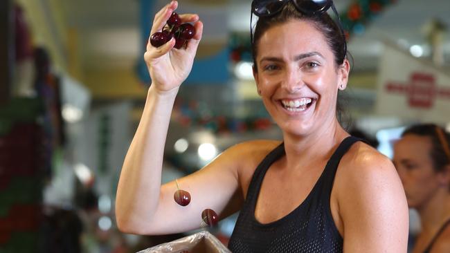 Bree Gargaro shopping for cherries at Cactus fruit and veg in Adelaide Central Markets. Picture: Tait Schmaal.