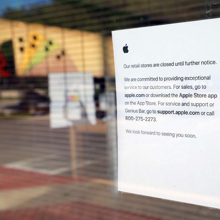 A sign fixed to a closed Apple store in the US. Picture: Tom Pennington / Getty Images / AFP