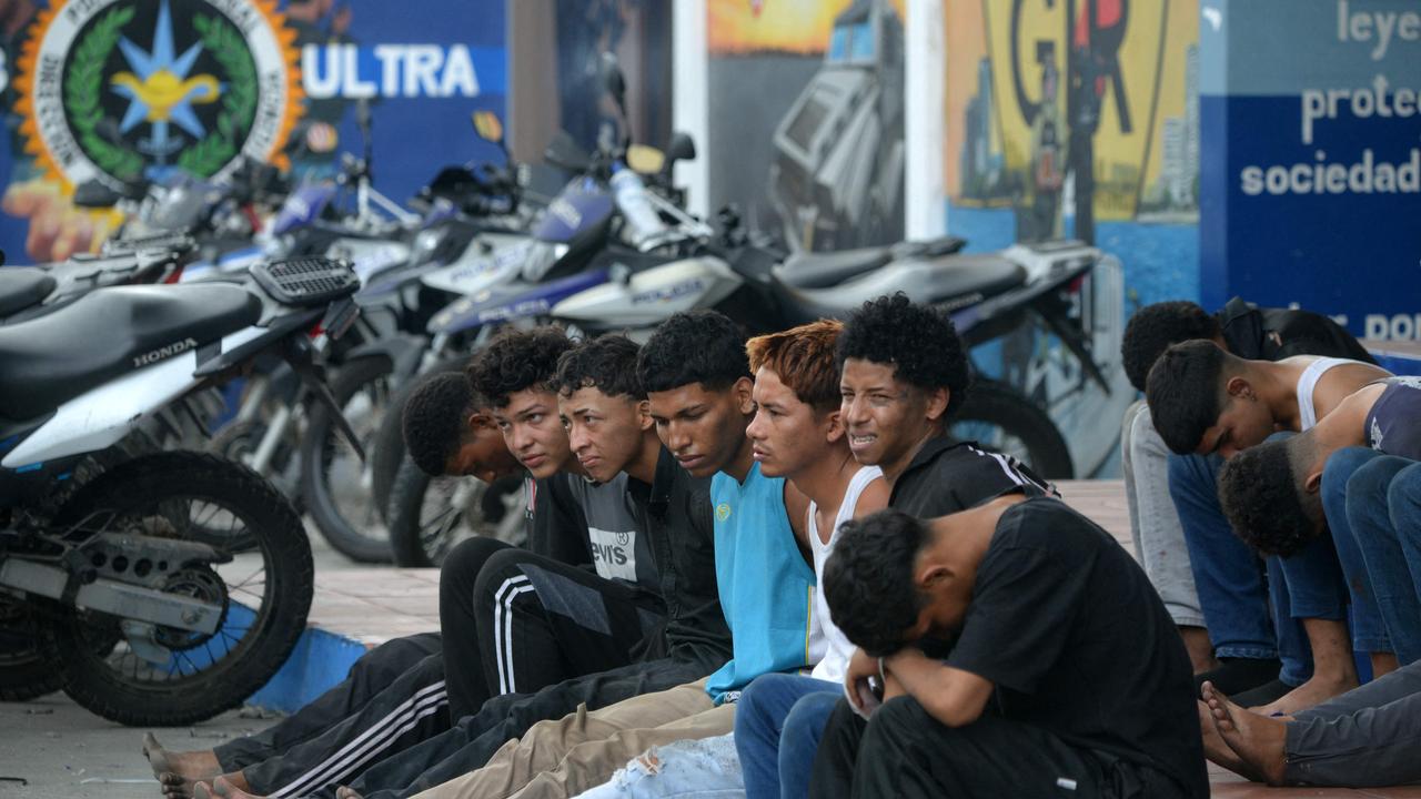 Thirteen arrested gunmen that stormed Ecuador's state-owned TC television channel are presented to the press at the Modelo Police Department. Picture: AFP