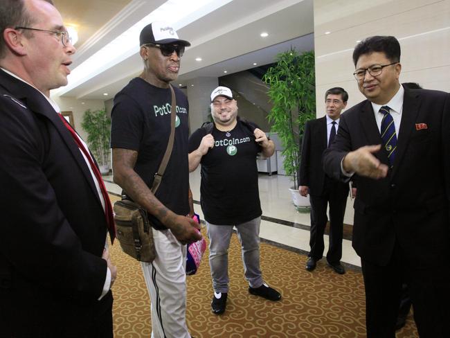 Former NBA basketball star Dennis Rodman (centre) is greeted by North Korea's Sports Ministry Vice Minister Son Kwang-ho (right) at Sunan International Airport in Pyongyang. Picture: AP Photo/Kim Kwang Hyon