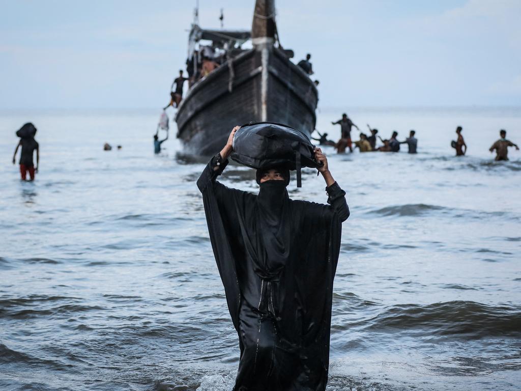 Rohingya refugees walks to the beach after the local community decided to temporarily allow them to land for water and food in Ulee Madon, Aceh province, Indonesia. Picture: Amanda Jufrian/AFP