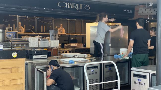 Staff at Charlie’s Restaurant Cafe and Bar in Surfers Paradise moving furniture in the business on Thursday afternoon.