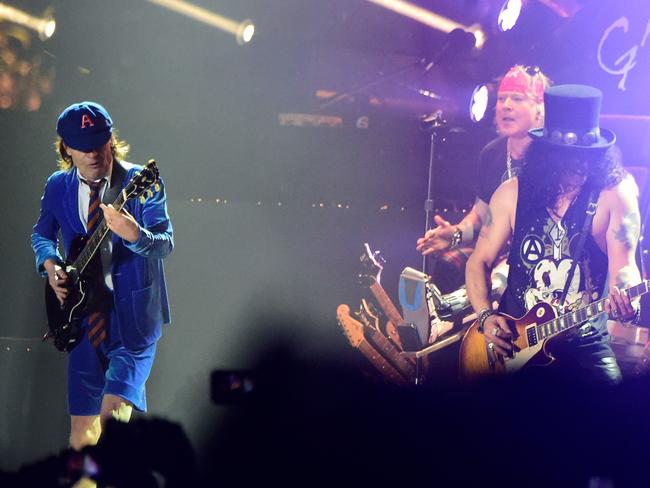 Angus Young of AC/DC performs onstage with Guns N' Roses.