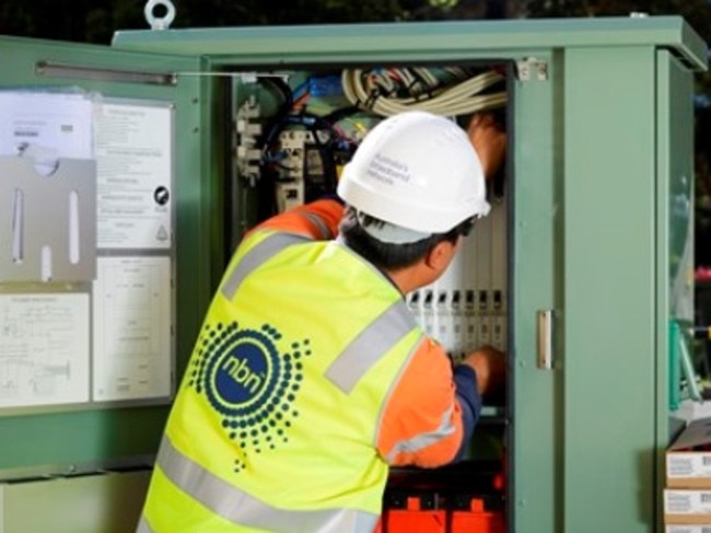 An NBN contractor installs a fibre-to-the-node box in Newcastle, NSW.