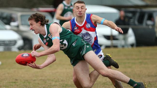 Tom Brindley fires of a handpass for Greensborough. Picture: Hamish Blair