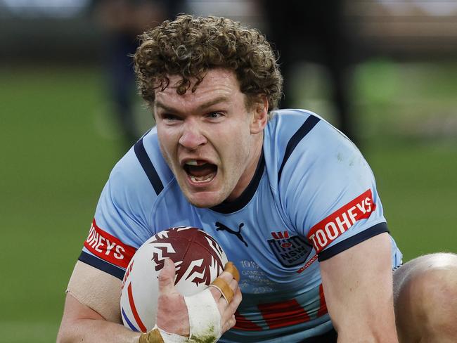MELBOURNE, AUSTRALIAÃ June 26 , 2024.  NRL State of Origin. Qld Maroons vs NSW Blues at the MCG.  Liam Martin of the Blues breaks through the Queensland defence to score the opening try    . Pic: Michael Klein