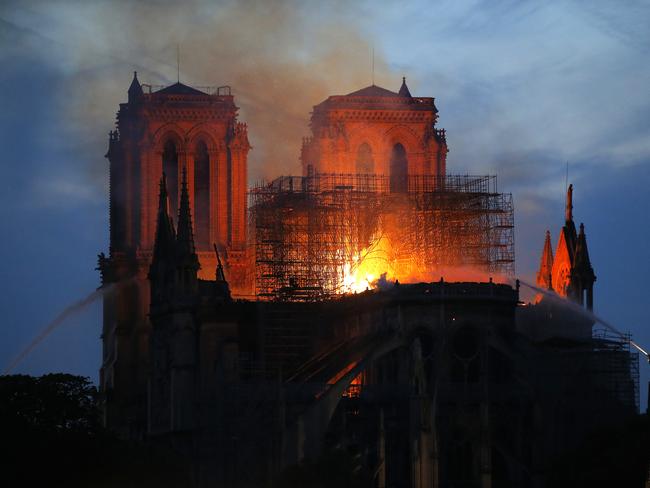 Firefighters tackle the blaze as flames and smoke rise from Notre Dame cathedral as it burns in Paris, Monday, April 15, 2019. (AP Photo/Michel Euler)