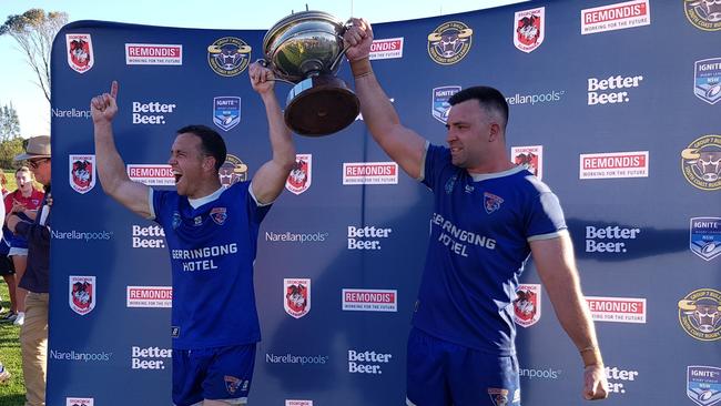 Rixon Russell and Nathan Ford hold the Illawarra Cup trophy aloft for Gerringong Lions. Picture: Steve Montgomery Sports Photography