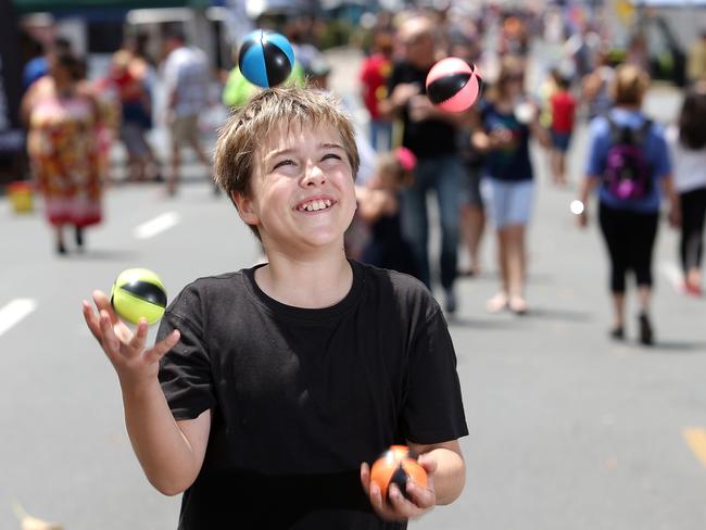 Conor Kikkert juggling at the Redcliffe markets to raise money to build wells in Zimbabwe. Picture: Josh Woning