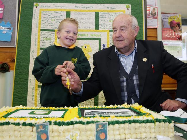 Kindergarten student Zane Graham with the longest-serving former principal John Emerton. Picture: Mark Scott